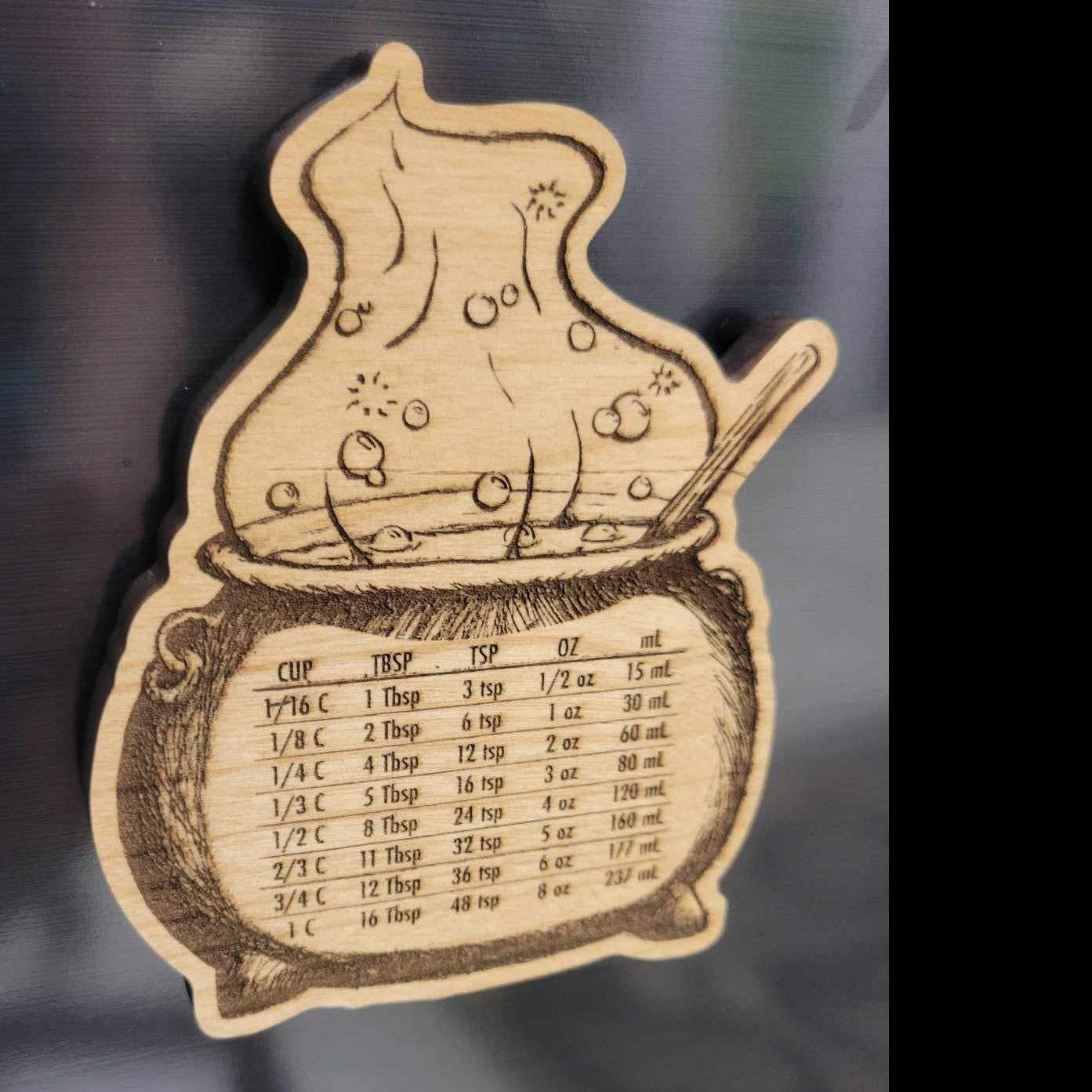 Potion bottle-shaped neodymium wood magnet with bubbly design and kitchen conversion chart, Halloween-themed by InkBird Print Studio.