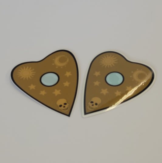 Heart-shaped InkBird Print Studio LLC vinyl planchette decals with sun, moon, stars, tiny skull, blue window; weatherproof stickers.