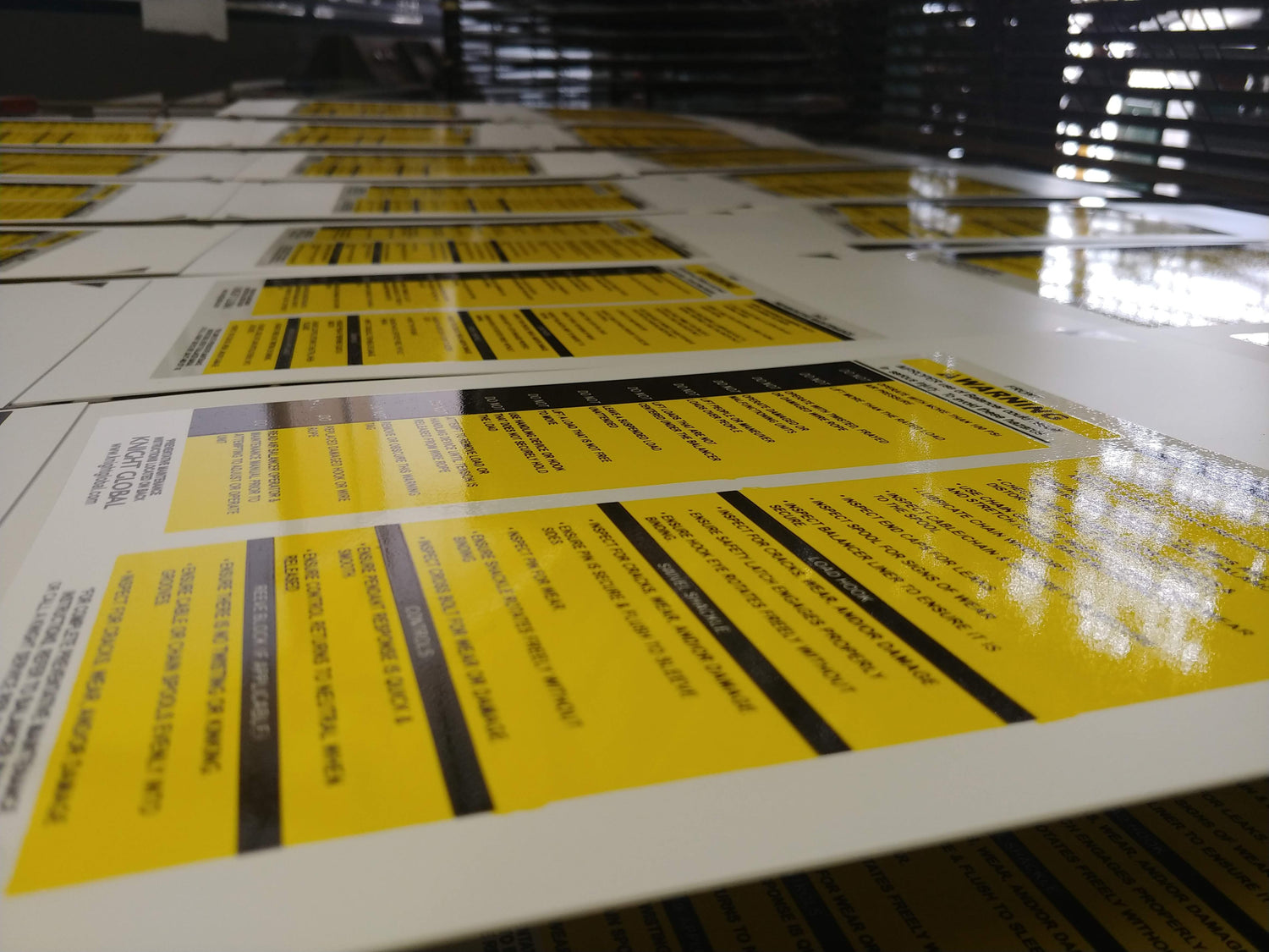 Yellow and black adhesive vinyl warning labels in rows, bold text, durable finish, standard letter size, ideal for safety signage.