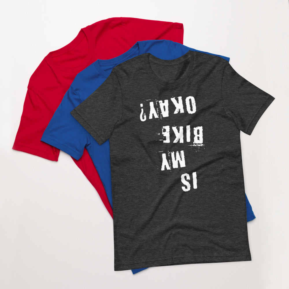 Stack of three tees—red, blue, and InkBird Print Studio’s “Is My Bike Okay?” shirt with white distressed upside-down text.