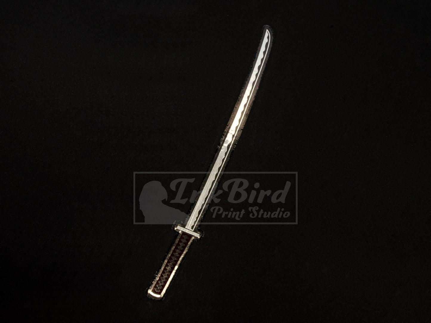 Vinyl sticker by InkBird Print Studio: metallic foil katana in silver and burgundy, sleek Japanese sword style. Adhesive backing.
